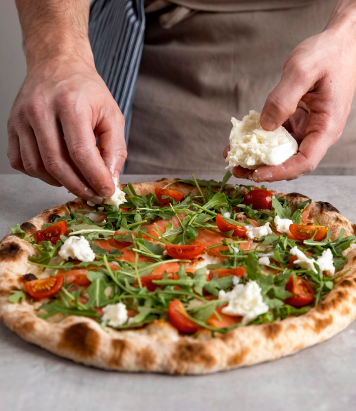 man-putting-mozzarella-pizza